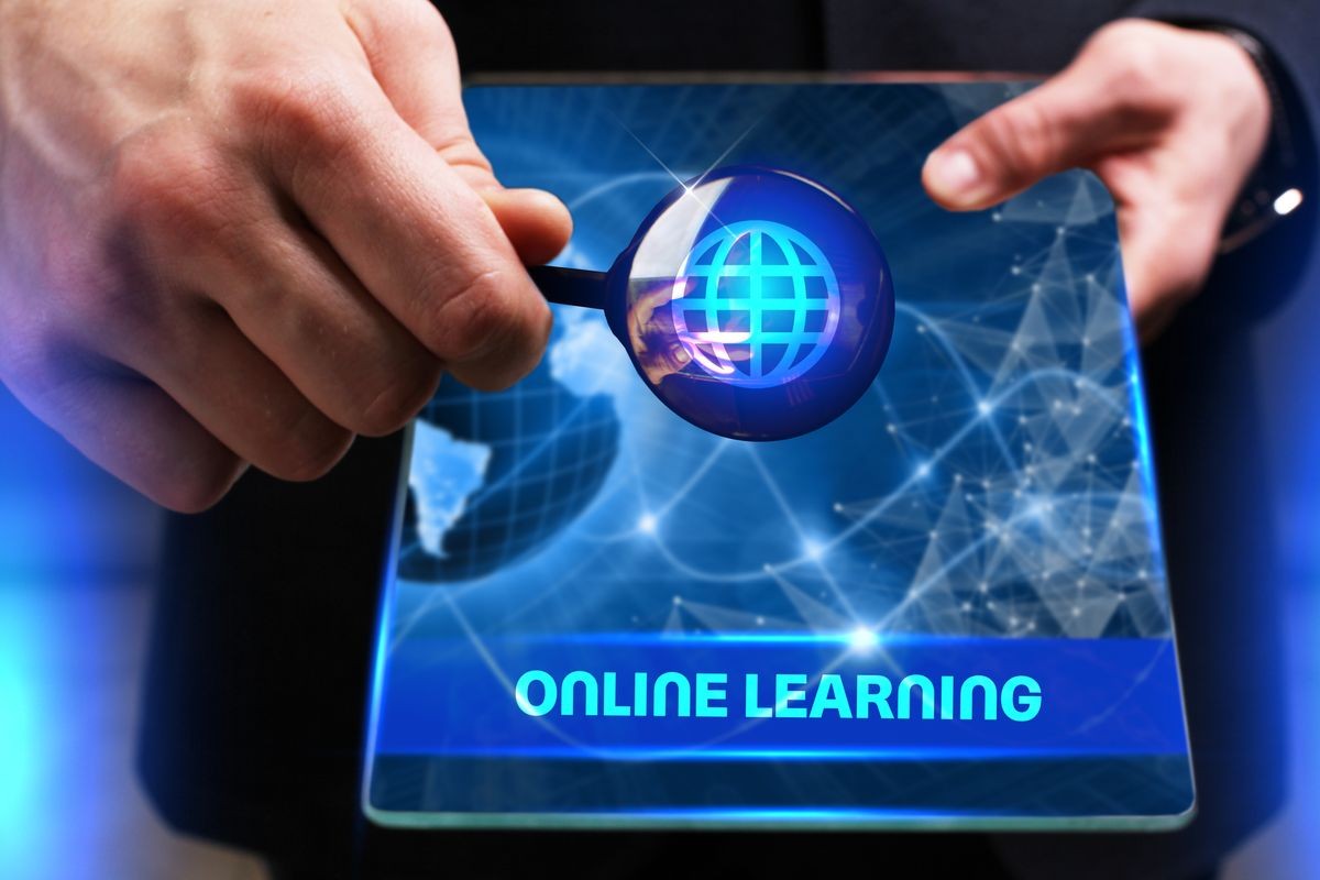 Business, Technology, Internet and network concept. Young businessman working on a virtual screen of the future and sees the inscription: Online learning